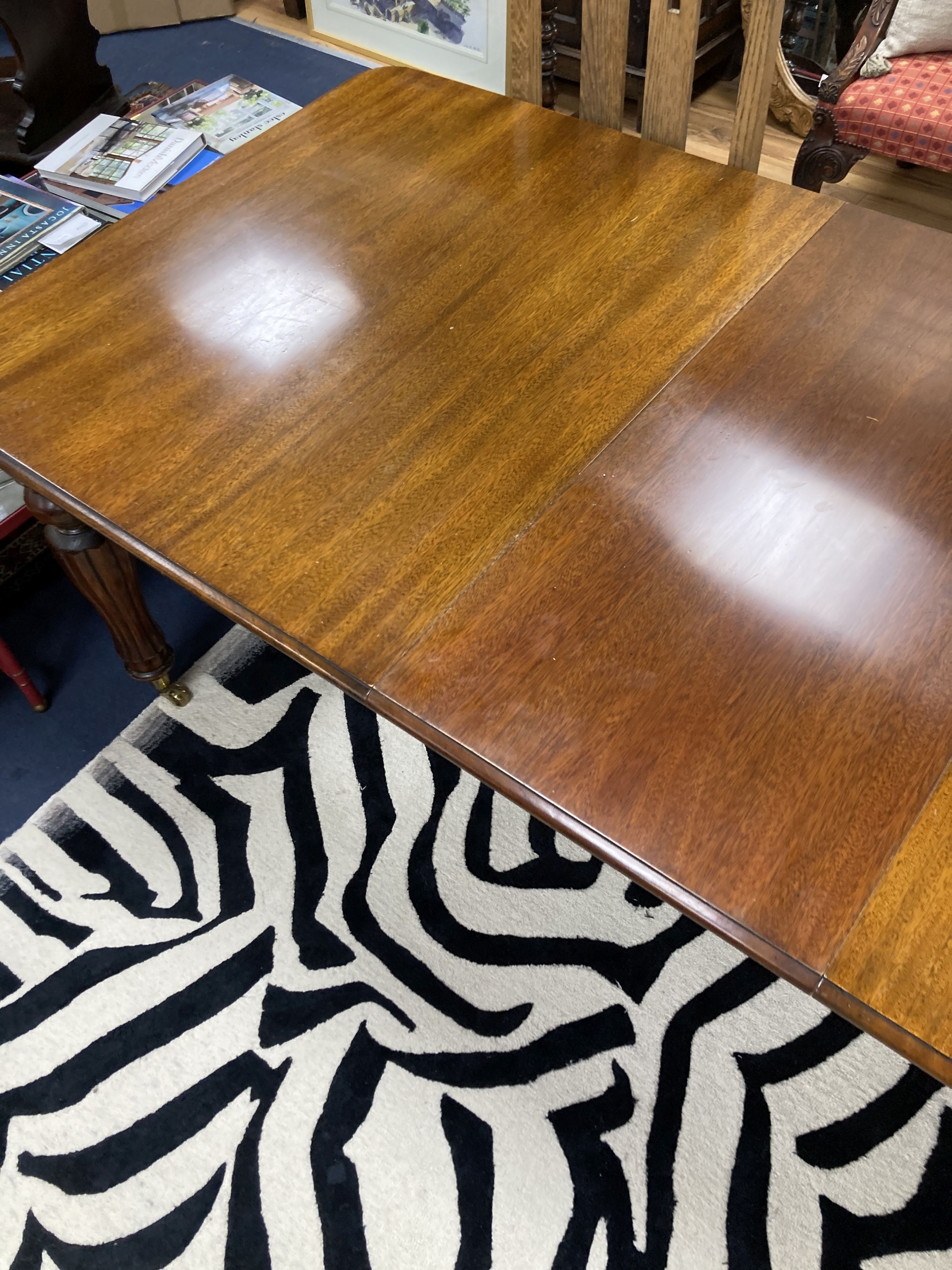 A Victorian style mahogany extending dining table. 214 extended, one spare leaf. W-100, H-74cm.